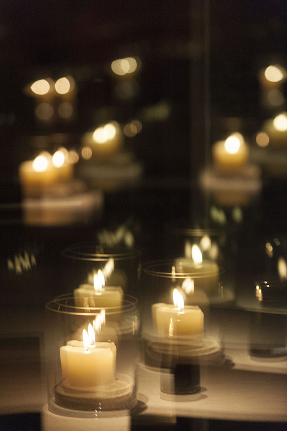 P.F. Chang's restaurant, grand opening at Briarwood Mall in Ann Arbor, MI on Dec 15, 2014. An interior glass door multiplies candles on a table.